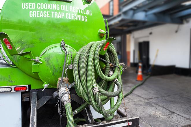 a grease trap being pumped by a sanitation technician in Panorama City